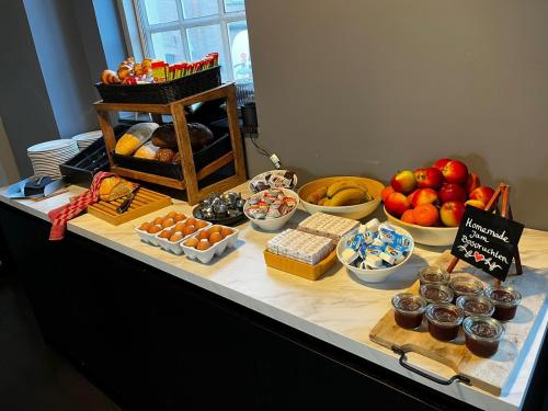 a buffet with different types of food on a table at Hotel Oostereiland in Hoorn