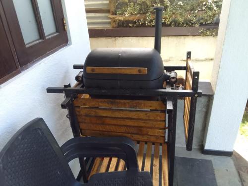 a grill sitting on top of a bench next to a window at Northern Residence in Jaffna