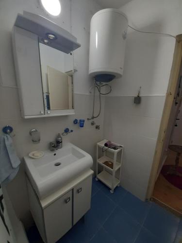 W łazience znajduje się biała umywalka i lustro. w obiekcie Apartman Oskar w mieście Bor