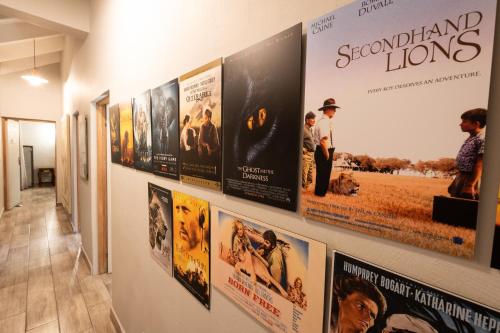 a row of movie posters hanging on a wall at Africa House in Hoedspruit