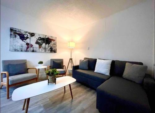 a living room with a couch and a table at Miami International Airport 1 in Miami
