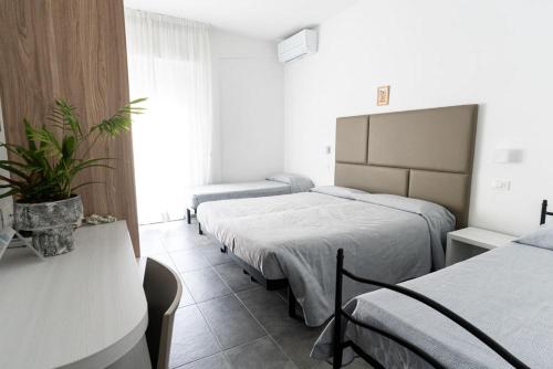 Postel nebo postele na pokoji v ubytování Hotel Eugenio