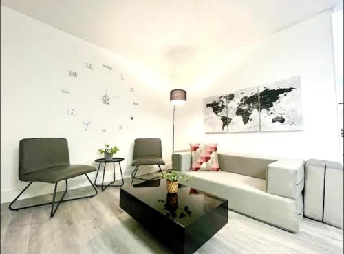 a living room with a white couch and two chairs at Miami International Airport 1 in Miami