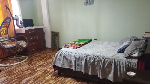 a bedroom with a bed and a dresser at Habitación Matrimonial Oruro Carnaval in Oruro