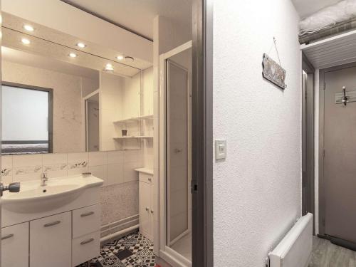 une salle de bain blanche avec un lavabo et un miroir dans l'établissement Studio cabine 5 pers, balcon, cuisine équipée, casier à ski - FR-1-404-351, à La Mongie