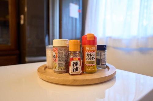 a wooden tray with condiments on a table at グリーンハウス in Nanjo