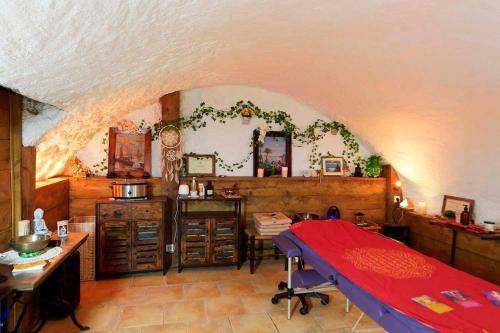 a bedroom with a red bed in a room at Chambres d'hotes - La Maison de Julie in Entrevaux
