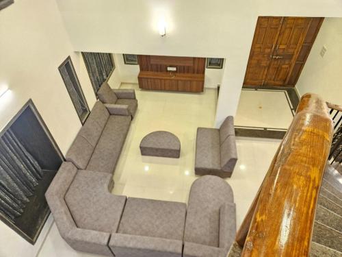an overhead view of a living room with a couch and chairs at Seven Villa with Swimming pool in Panchgani