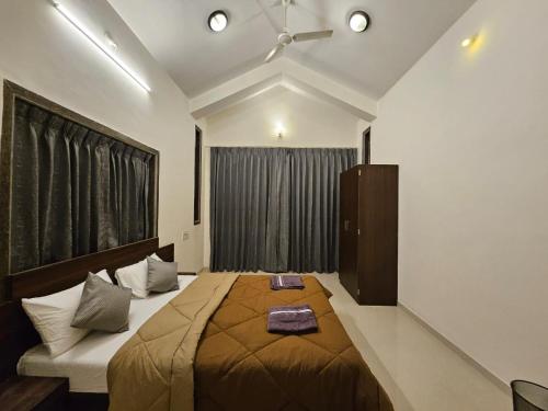 a bedroom with a large bed and a window at Seven Villa with Swimming pool in Panchgani