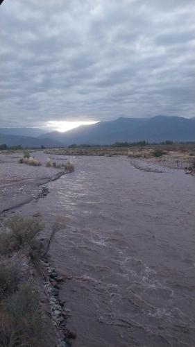 a view of a river in the middle of a field at Alojamiento Shanti in Vista Flores