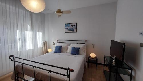 um quarto com uma cama e uma televisão de ecrã plano em Antonia's Guest House em Rimini