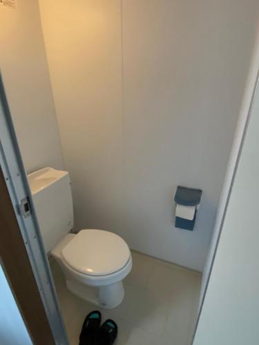 a small bathroom with a white toilet in a room at A&B Omoromachi Station in Naha