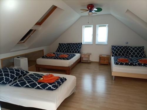 een zolderkamer met 2 bedden en een bank bij Schöne Wohnung mit Whirlpool und Sauna 