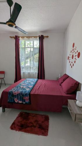 a bedroom with a large bed and a window at An&Sy Family House in Surinam