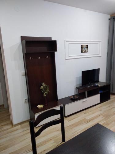 a living room with a table and a tv at Apartmani Jaz 24 in Budva