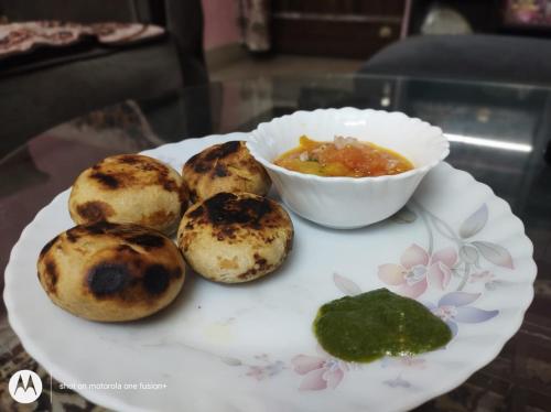 a plate with muffins and a bowl of soup at Shree Nanda Guest House in Varanasi