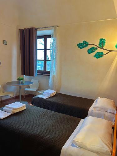 Кровать или кровати в номере Foresteria La Rubbianetta