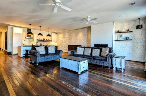 a living room with two couches and a table at Cherry Street Luxury Apartment in Helena