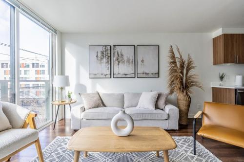 a living room with a couch and a table at Seattle Modern and Stylish Penthouse Apartment (Wifi, Pet Friendly, Rooftop) in Seattle