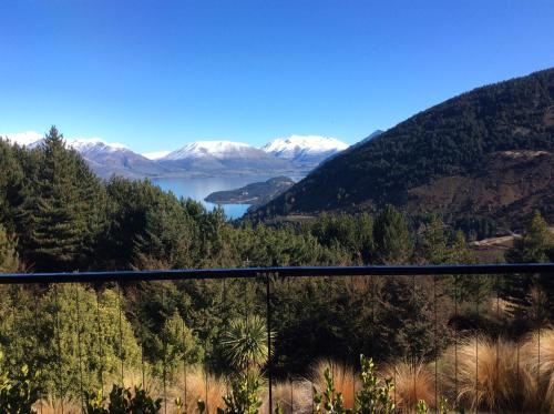 a view of a lake and snow covered mountains at The Alpine Retreat in Queenstown