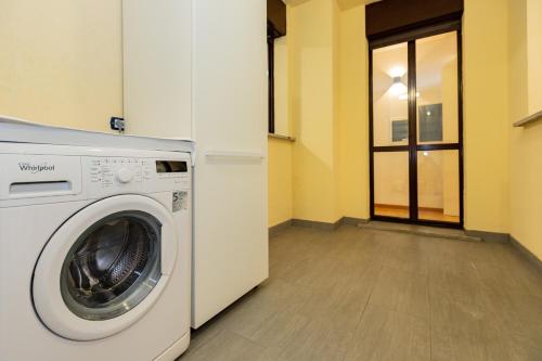a washing machine in a room with a window at PREMUDA20 Milan Elegant Apartment in Milan