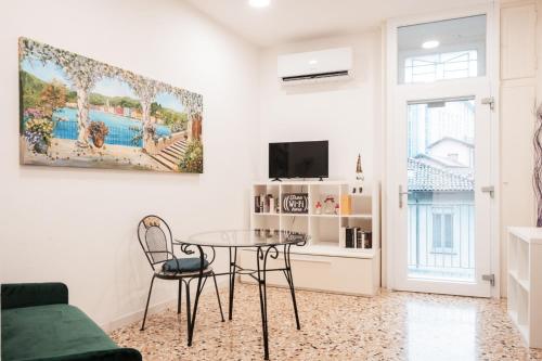 a living room with a table and a tv at Casa Imbarcadero in Lecco