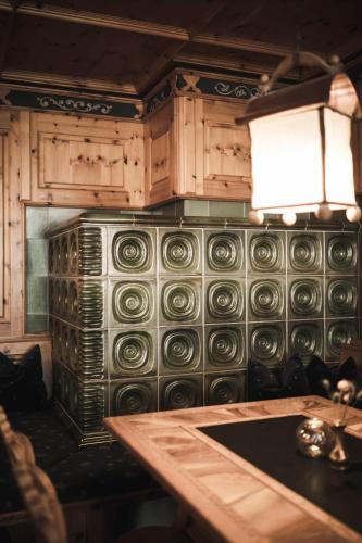 a kitchen with a stove and cabinets and a table at Sporthotel Bachmann in Gargellen