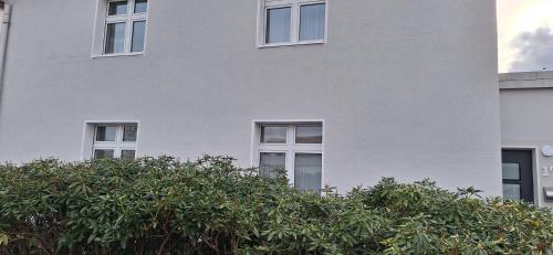 a white building with trees in front of it at Blumenblick in Kirchhain