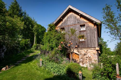 an old house with a garden in front of it at La Grange d'Hannah - gîte & chambre d’hôtes de charme in Orbey