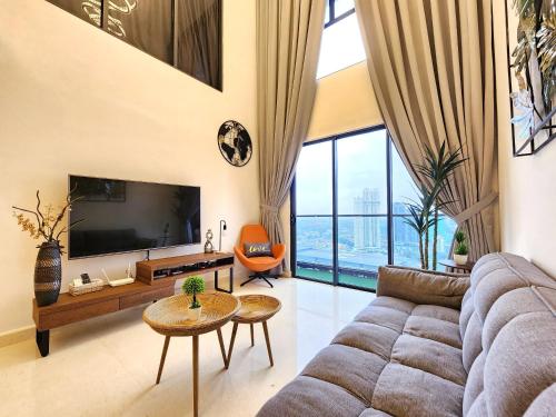Loft Suite CityView near JB CIQ 7Pax في جوهور باهرو: غرفة معيشة مع أريكة وتلفزيون