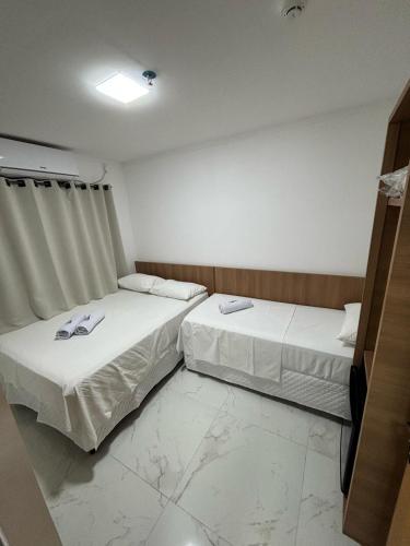 Ένα ή περισσότερα κρεβάτια σε δωμάτιο στο Hotel Mãe Morena