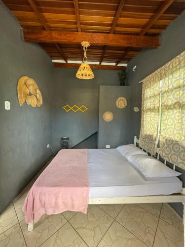 a bedroom with a large bed in a room at Hostel das fadas in Paraty