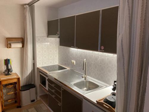a kitchen with a sink and a counter top at My Fair - Koksijde in Koksijde