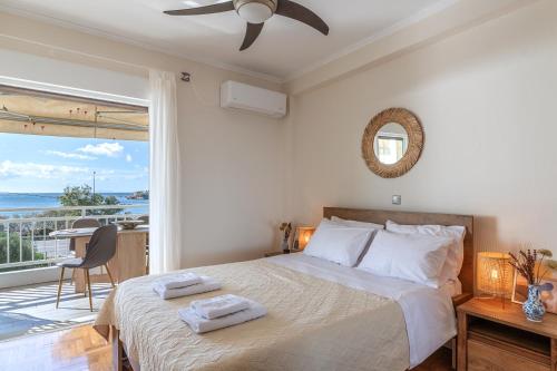 a bedroom with a bed with a view of the ocean at Amazing sea view apartment in Lagonissi in Kalívia Thorikoú