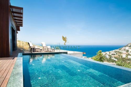 a swimming pool with a view of the ocean at Villa Calista by Important Group Travel in Yalıkavak
