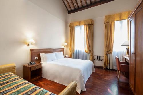 Postel nebo postele na pokoji v ubytování Hotel Alle Acque