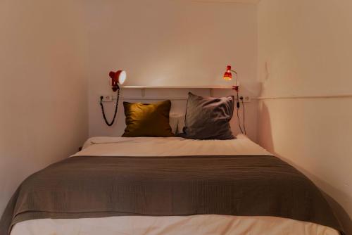 a bedroom with a bed with a phone on the wall at Acogedor apartamento en Bilbao in Bilbao