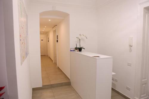 a hallway with white walls and a white counter at Boutique Rooms B&B in Catania