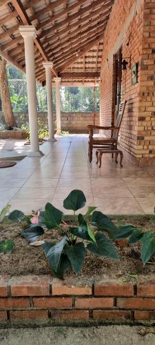 a porch with a bench and a plant in front at Nature love Negombo in Kochchikade