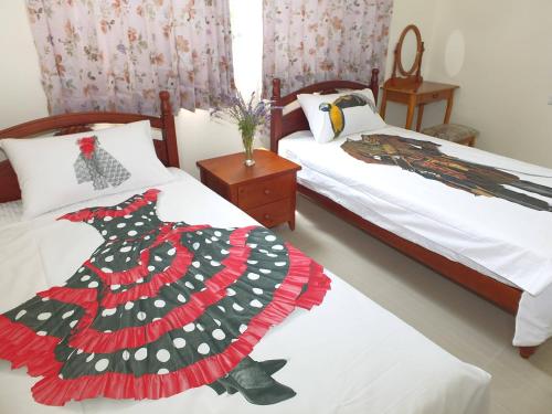 a bedroom with two beds with a dress on the bed at Village Tree B&B in Jian