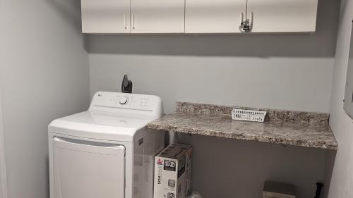 a kitchen with a counter top next to a washer at Robin's Nest Savannah in Savannah