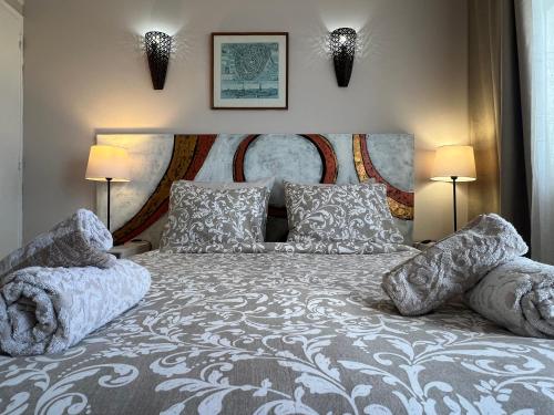 a bedroom with a large bed with two lamps at Casa T'Isabel - Fisherman's Beach - 2 bedrooms in Albufeira