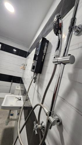 a bathroom with a hair dryer and a sink at DUSUN TOK SYED, ECOTHERAPY VILLAGE in Pendang