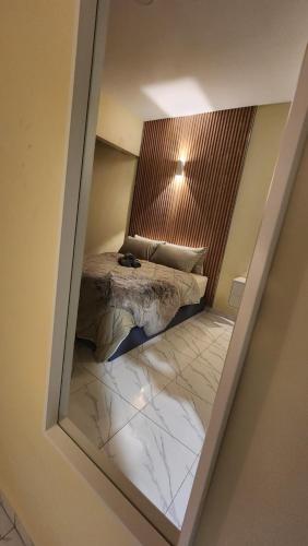 PendangにあるDUSUN TOK SYED, ECOTHERAPY VILLAGEの鏡にベッドが備わるベッドルームの反射