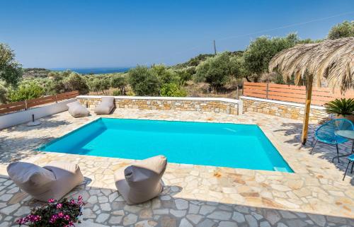 a swimming pool in a patio with chairs around it at Villa Luna in Kavála