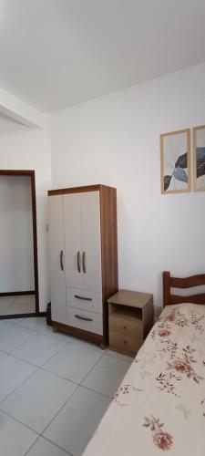 a bedroom with a bed and a dresser at Hostel Lar dos Idosos e Adultos in Salvador