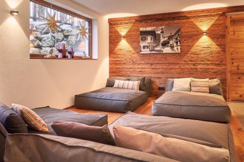 a living room with two beds and a couch at designchalets auf 685 in Reit im Winkl