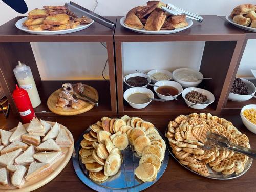 a table with plates of different types of pastries at Oasi in Kato Loutraki