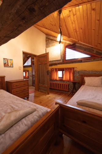 a bedroom with two beds in a room with wooden ceilings at Casa de Artes Guest House in Balchik