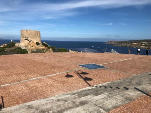 a tennis court on top of a hill with a castle at Alba Majore beach apartment in Rena Majore